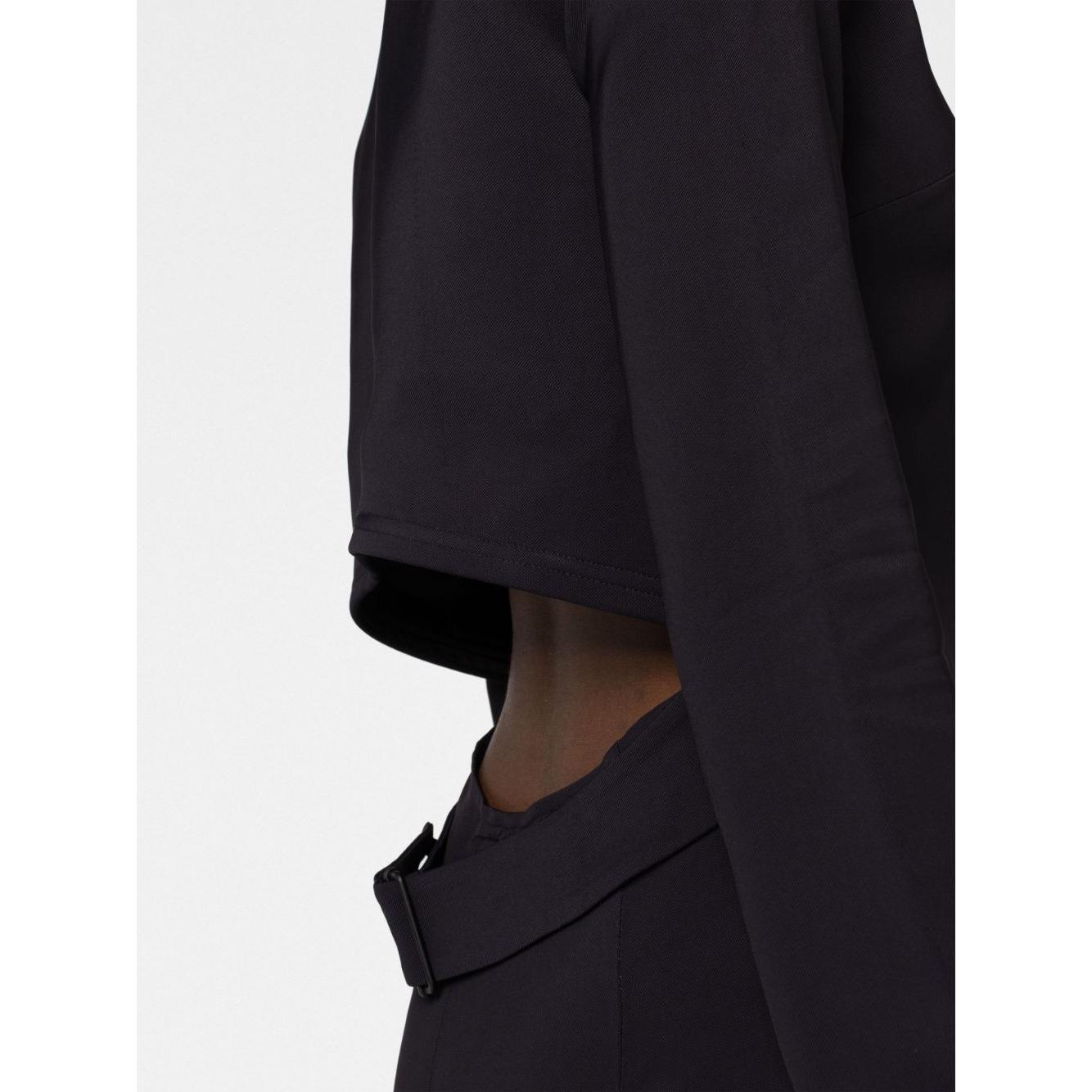 Close-up of 032C 'Kicked Back' black dress with cut-out detail, rear zip, round neck, and long sleeves.