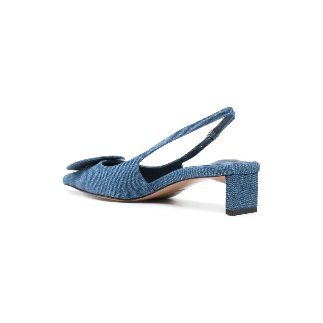 Jacquemus cerulean blue denim slingback with pointed toe and sculpted heel, featuring circle appliqué and buckle-fastening strap.