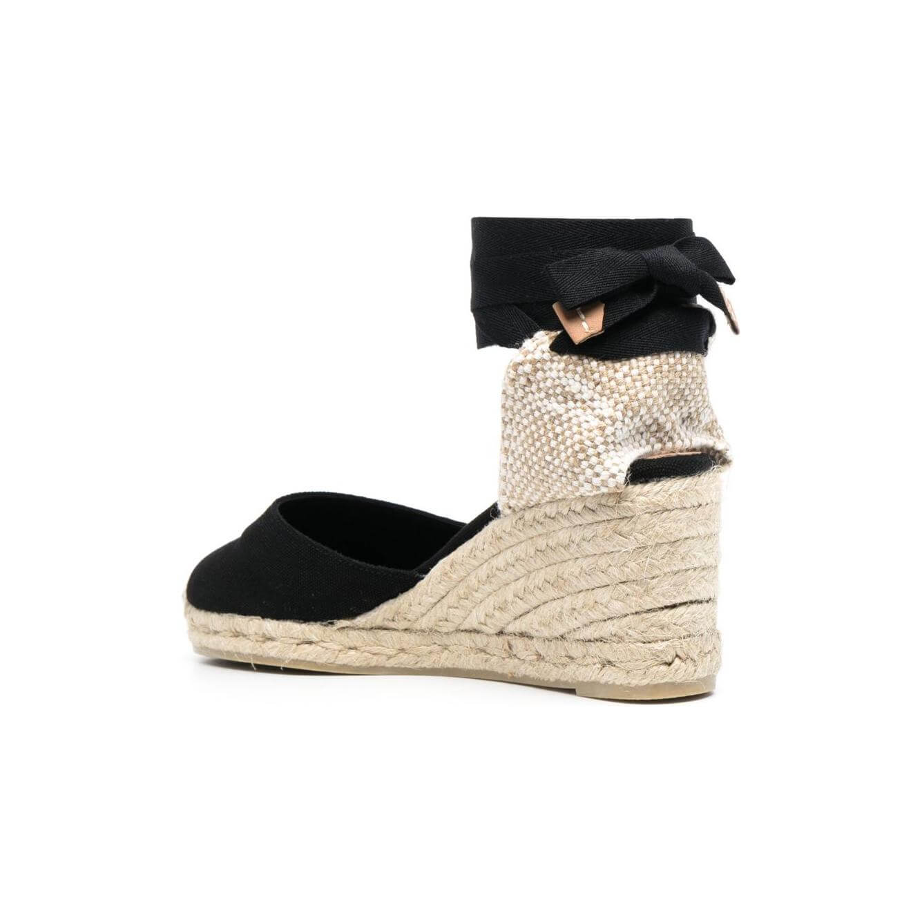 Castaner black flat shoes with espadrille wedge heel, round toe, lace-up ankle detail, branded insole, side view of Carina canvas design.