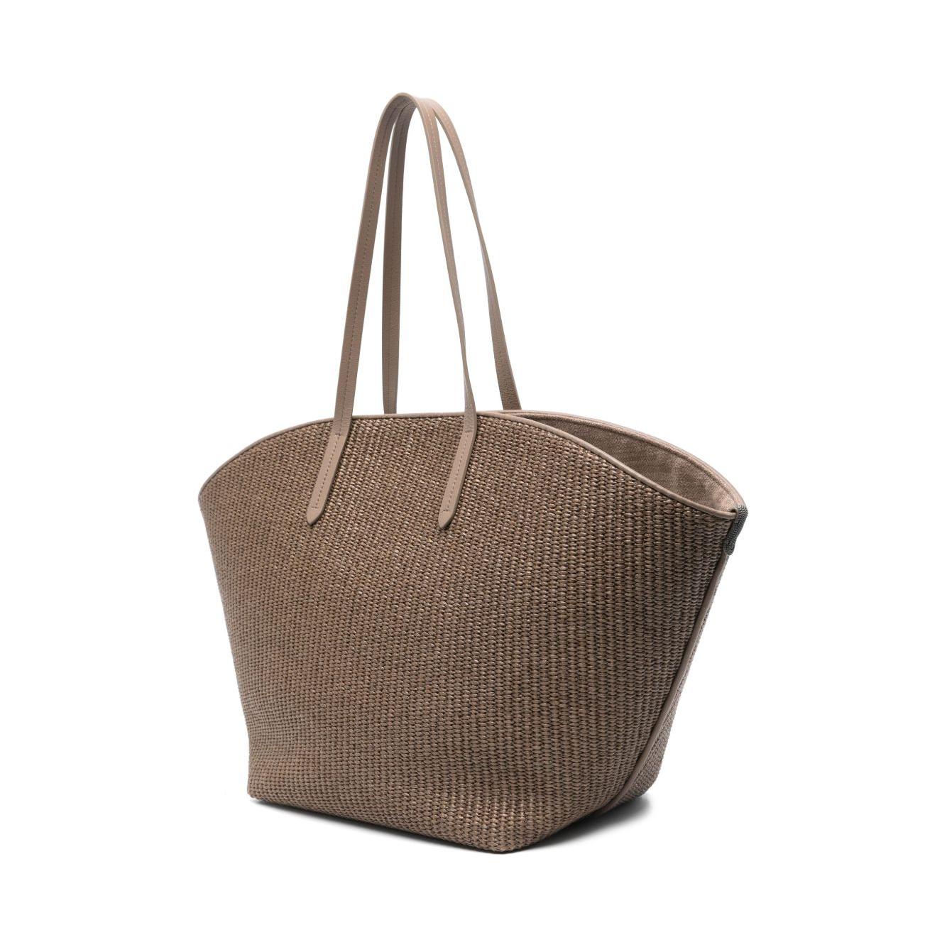 Brunello Cucinelli brown woven tote bag with signature Monili chain, flat top handles, and protective dust bag, elegant raffia design.