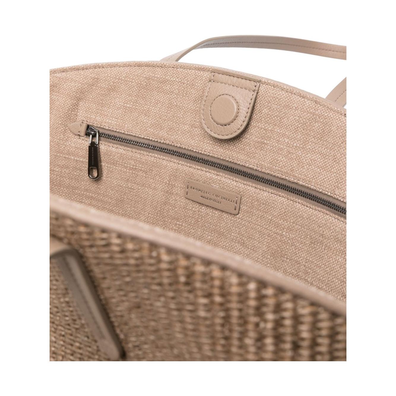 Interior view of Brunello Cucinelli brown woven tote bag with Monili chain detail, magnetic fastening, and protective dust bag included.