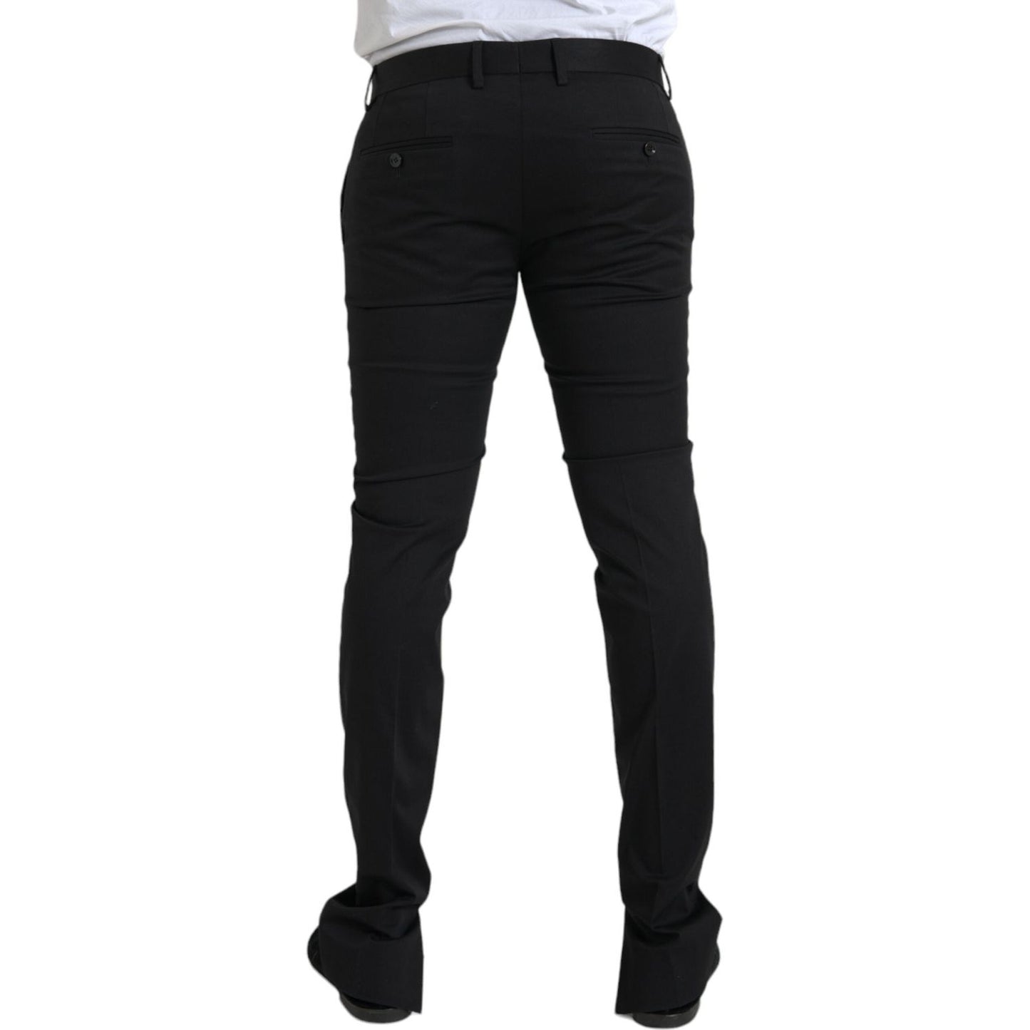 Rear view of Dolce & Gabbana black cotton stretch skinny dress pants, slim fit with zipper closure, high craftsmanship, made in Italy.