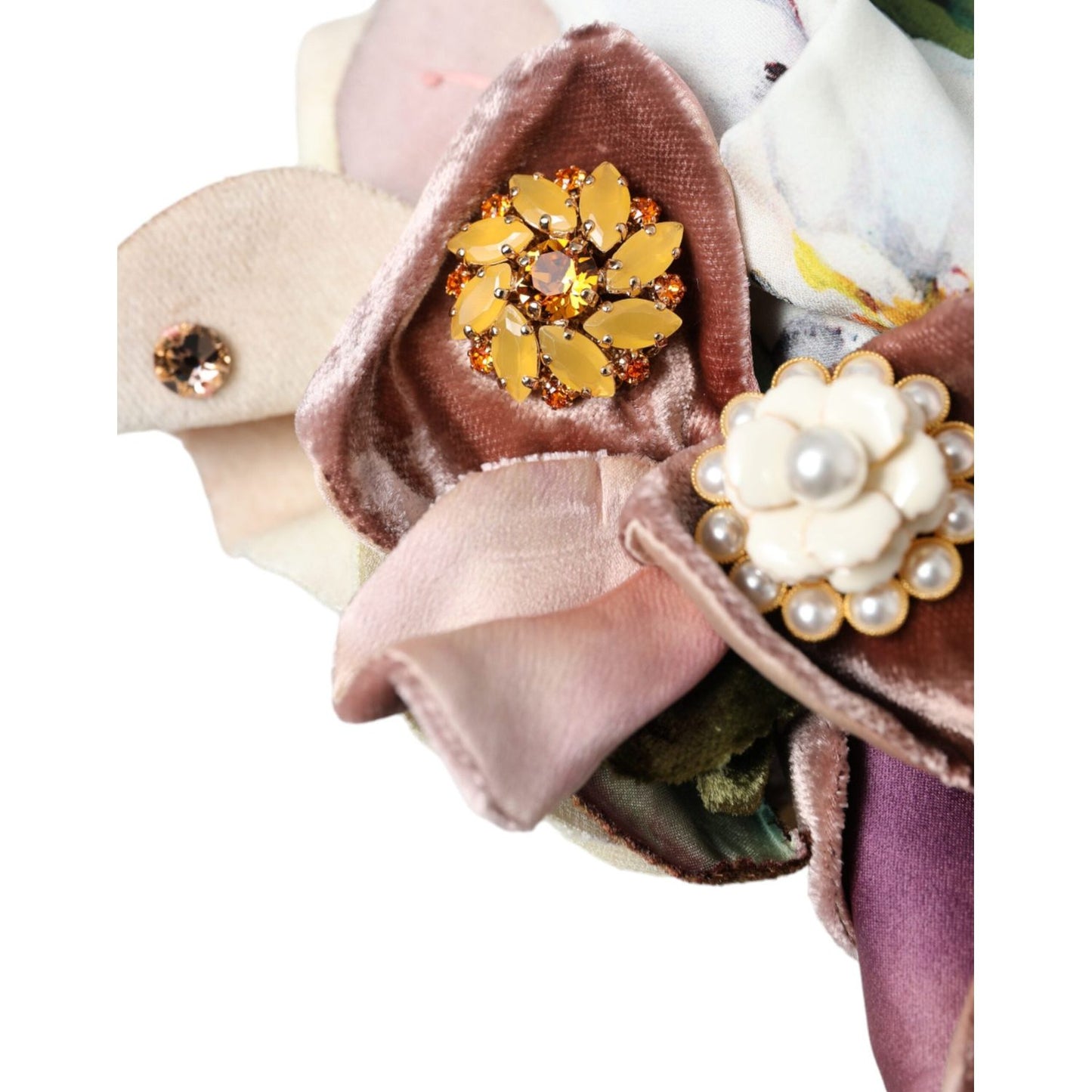 Close-up of floral motif detail on Dolce & Gabbana turban hat, featuring pink and cream velvet petals with jeweled accents.