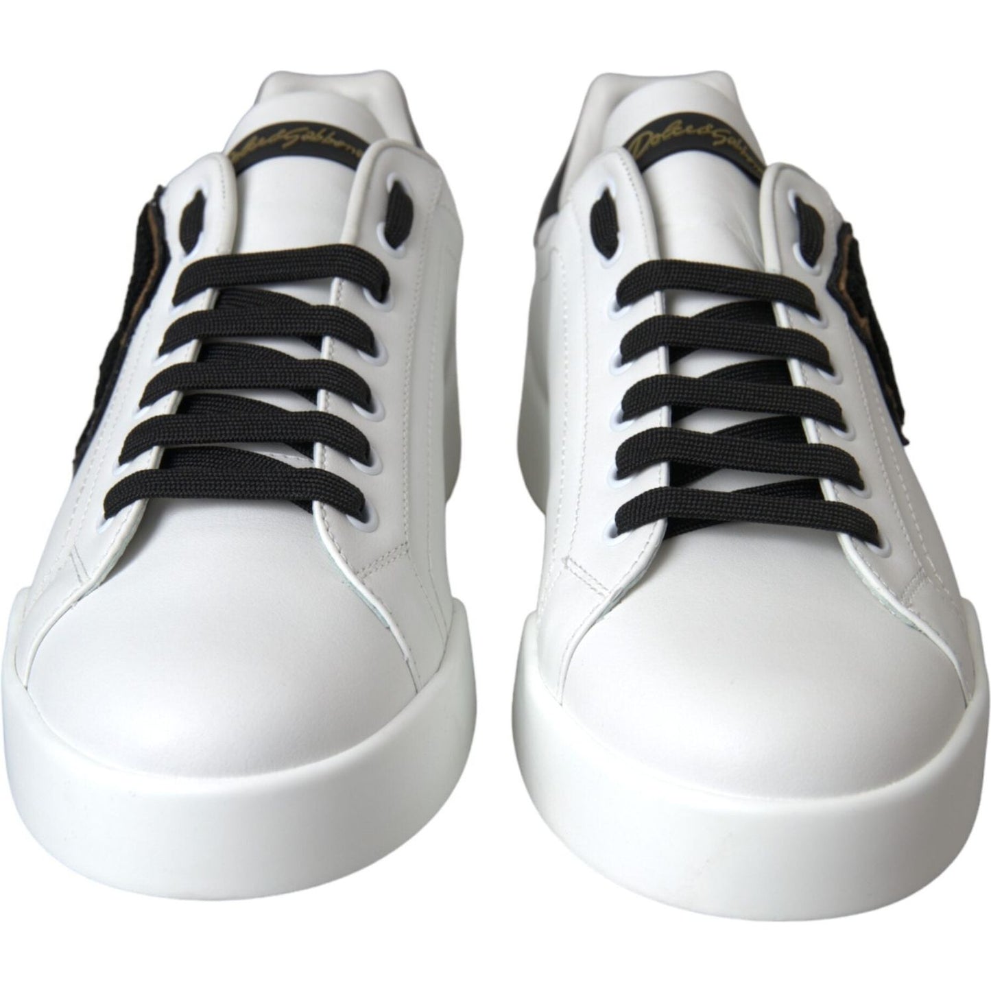 Dolce & Gabbana white leather sneakers, featuring DG logo, black laces, and rubber sole. Made in Italy. Casual low top design.