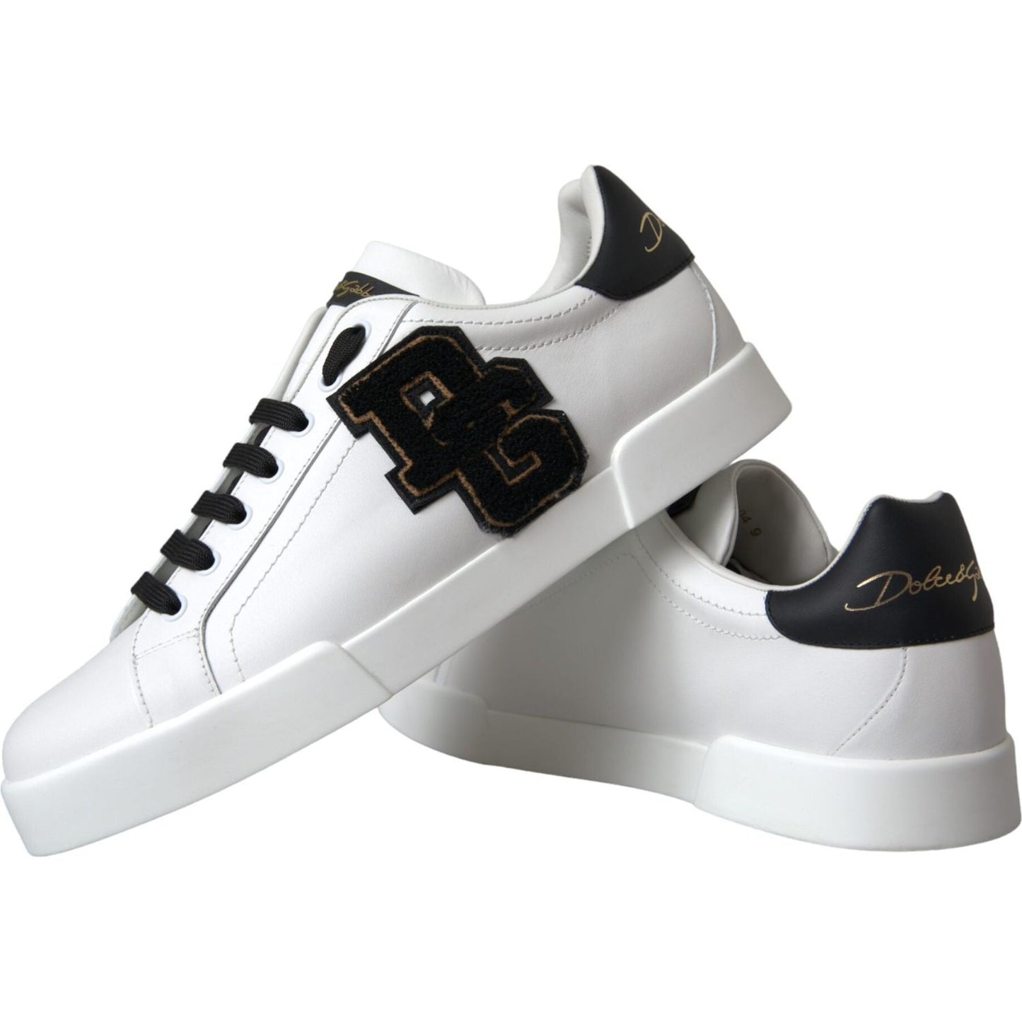 Dolce & Gabbana white leather sneakers with DG logo, black accents, lace-up closure, and rubber sole. Made in Italy.