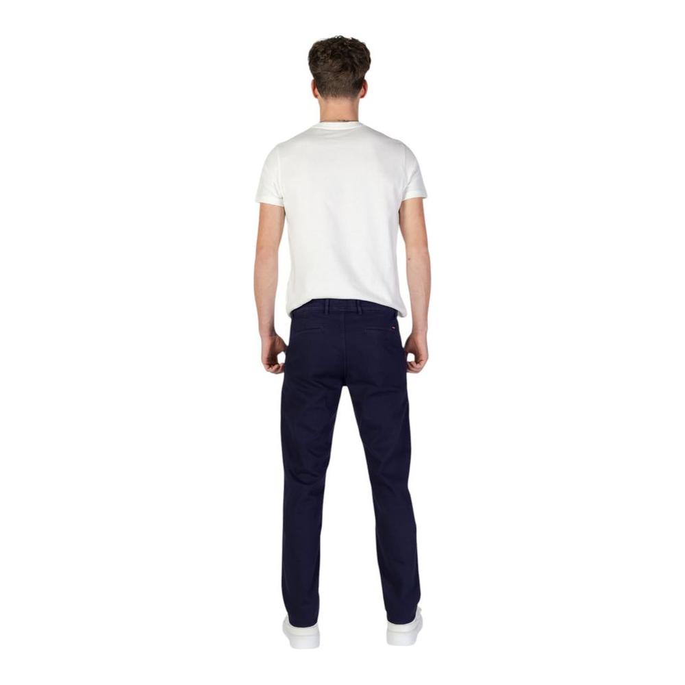 Rear view of man wearing Hugo Boss blue cotton slim pants from the Fall/Winter collection.