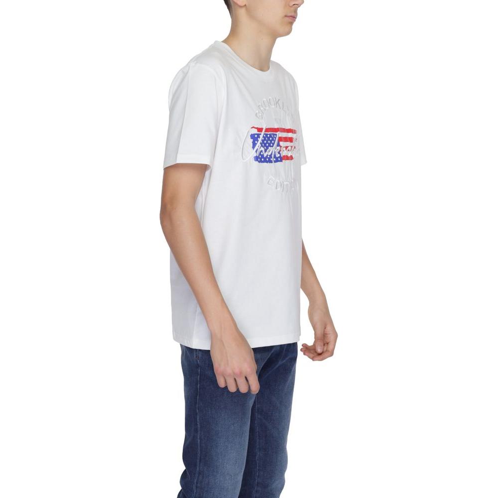 Man wearing Underclub white cotton T-shirt with graphic design, part of the spring/summer collection, paired with blue jeans.