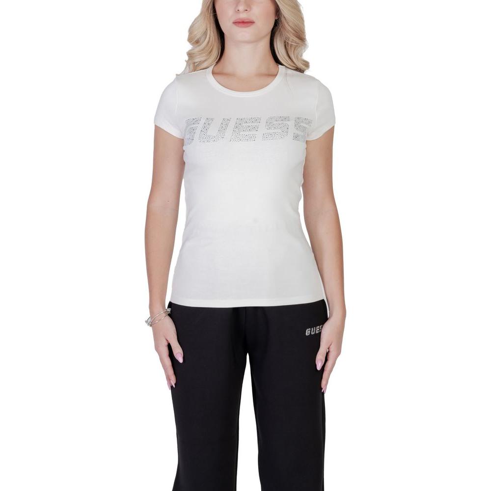 Woman wearing Guess Active KIARA short-sleeve cream cotton t-shirt with embossed logo, highlighting a comfortable, stylish fitted design.