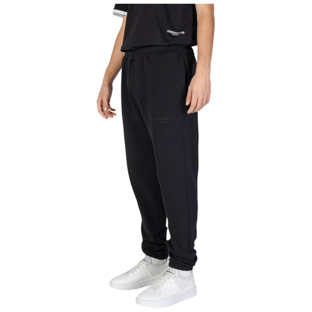 Men's black cotton pants from Underclub, ideal for fall and winter, showcasing casual style with white sneakers.