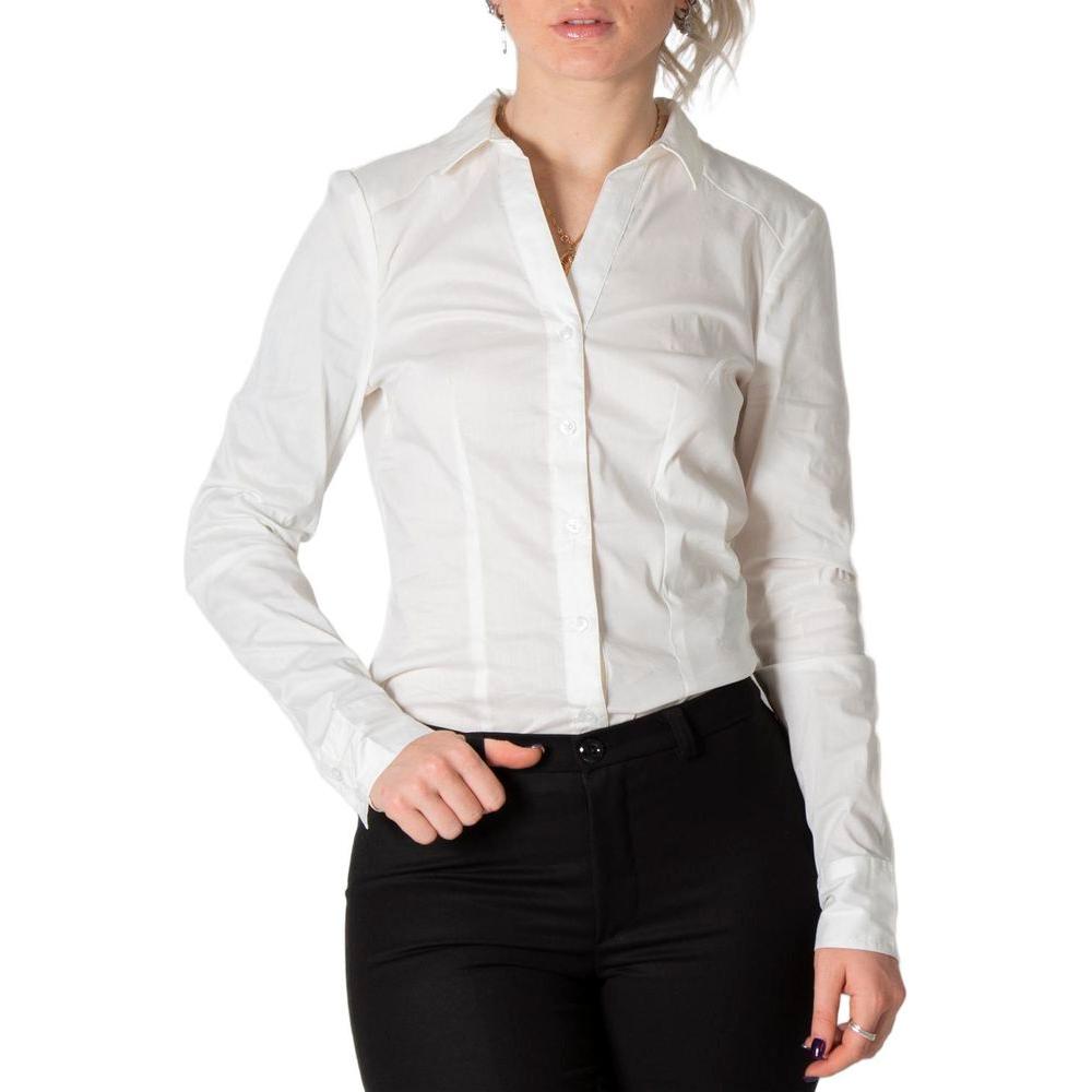 Woman wearing white long-sleeve button-up shirt with black pants