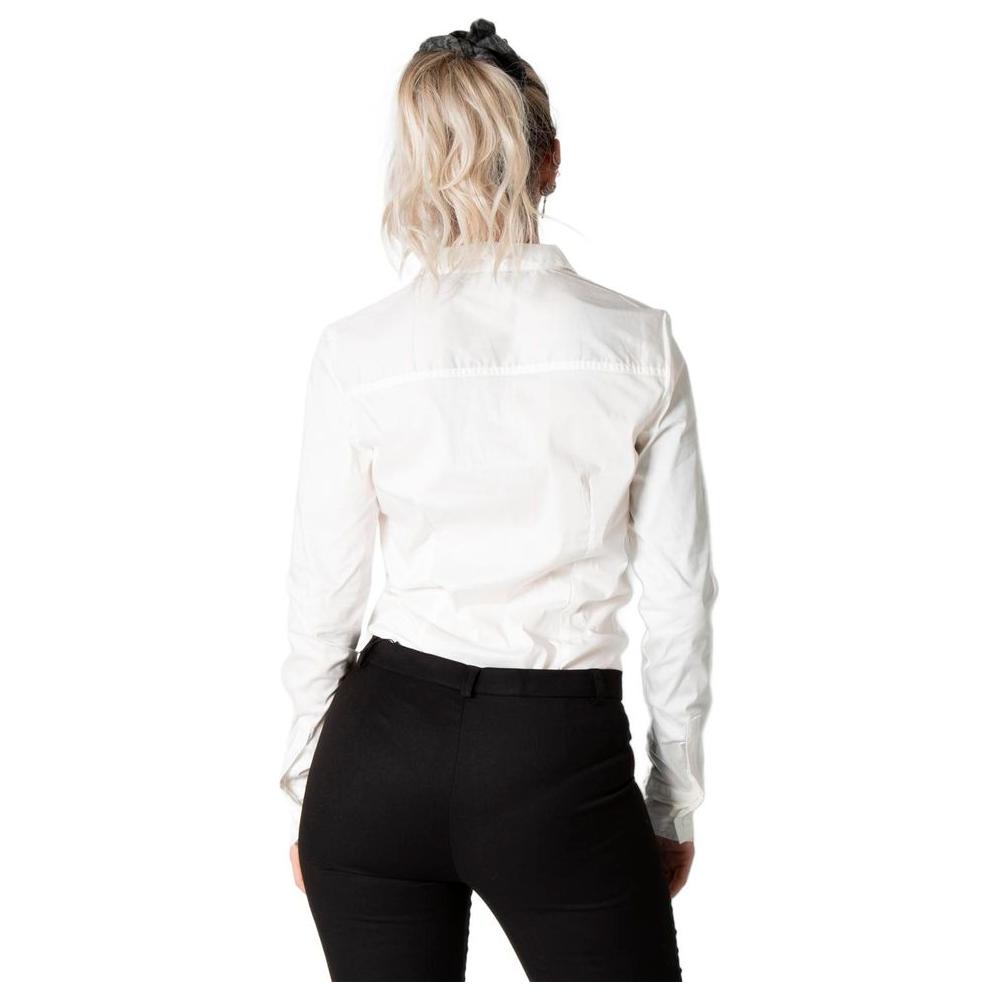 Back view of woman wearing Vero Moda cream cotton top and black pants