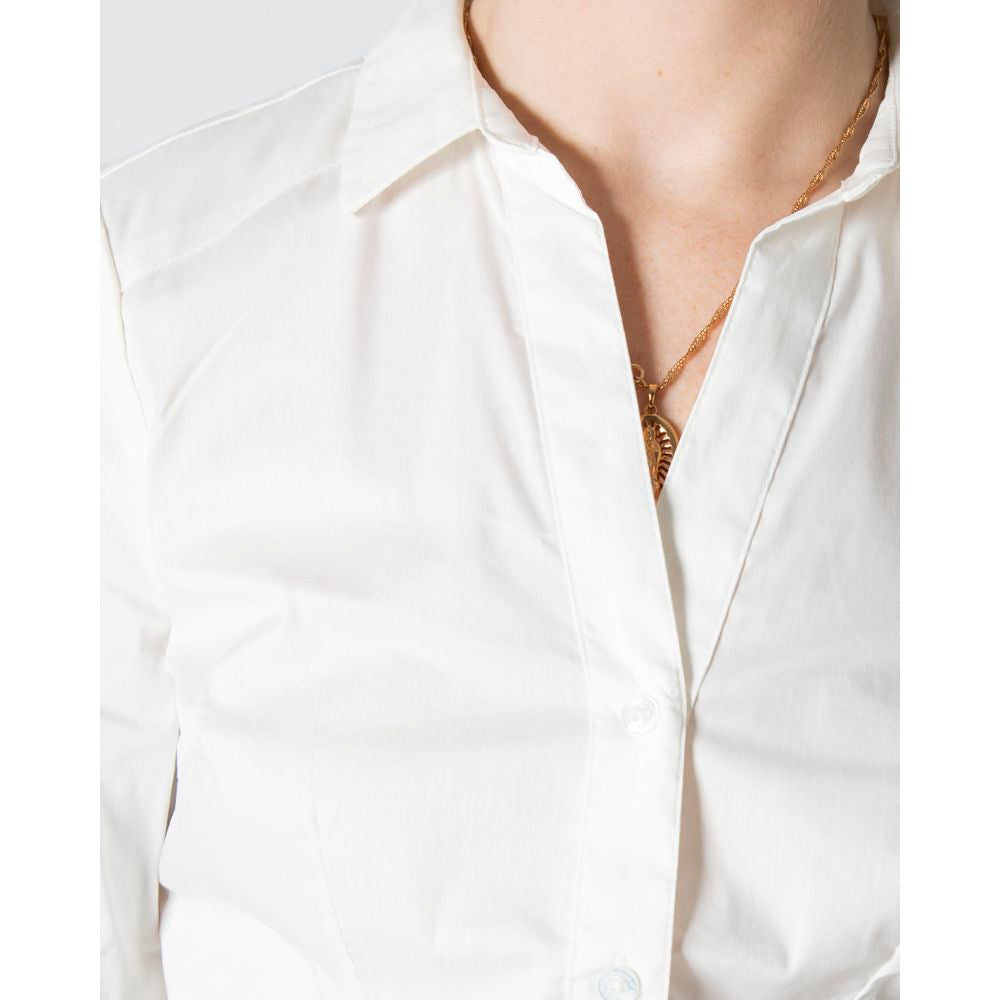Person wearing a white long-sleeve cotton shirt with a gold necklace visible at the collar.