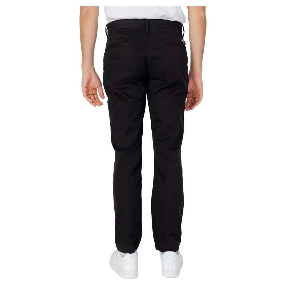 Back view of men's black Tommy Hilfiger tapered jeans, organic cotton, spring/summer collection, shown on model.