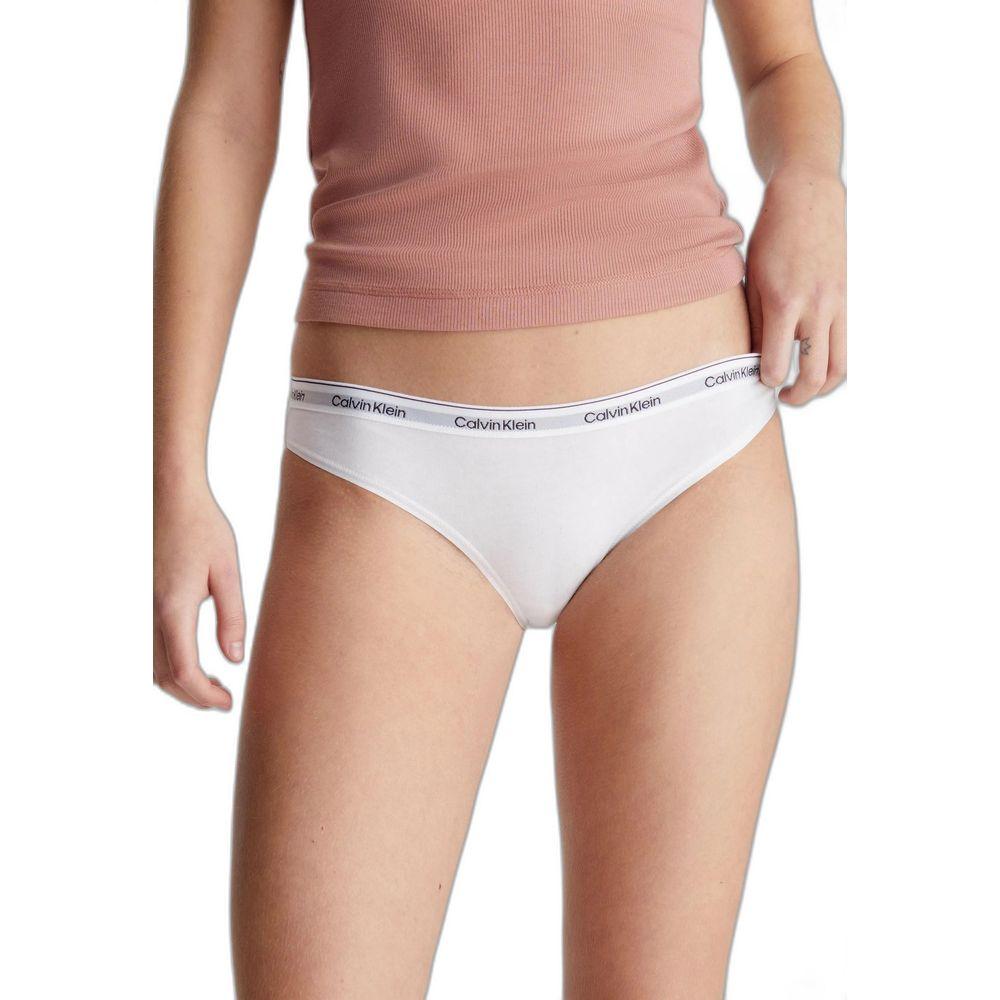 Woman wearing white Calvin Klein cotton underwear with logo waistband, showcasing modern design and comfort for everyday wear.