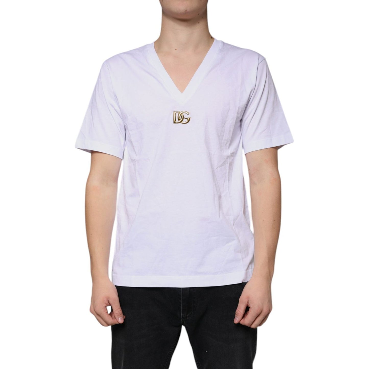 Dolce & Gabbana white cotton v-neck t-shirt with metal DG logo and short sleeves, minor front stains and logo color issues.