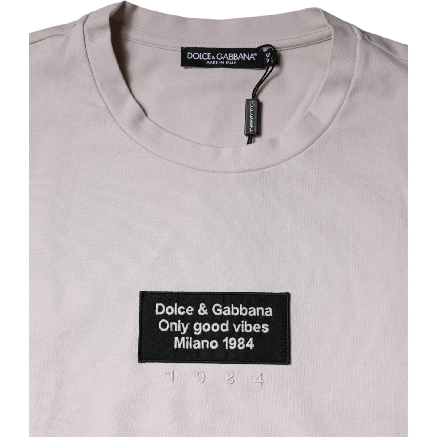 Dolce & Gabbana beige crew neck t-shirt with logo and embroidered graphic print, Milano 1984, made from cotton blend.