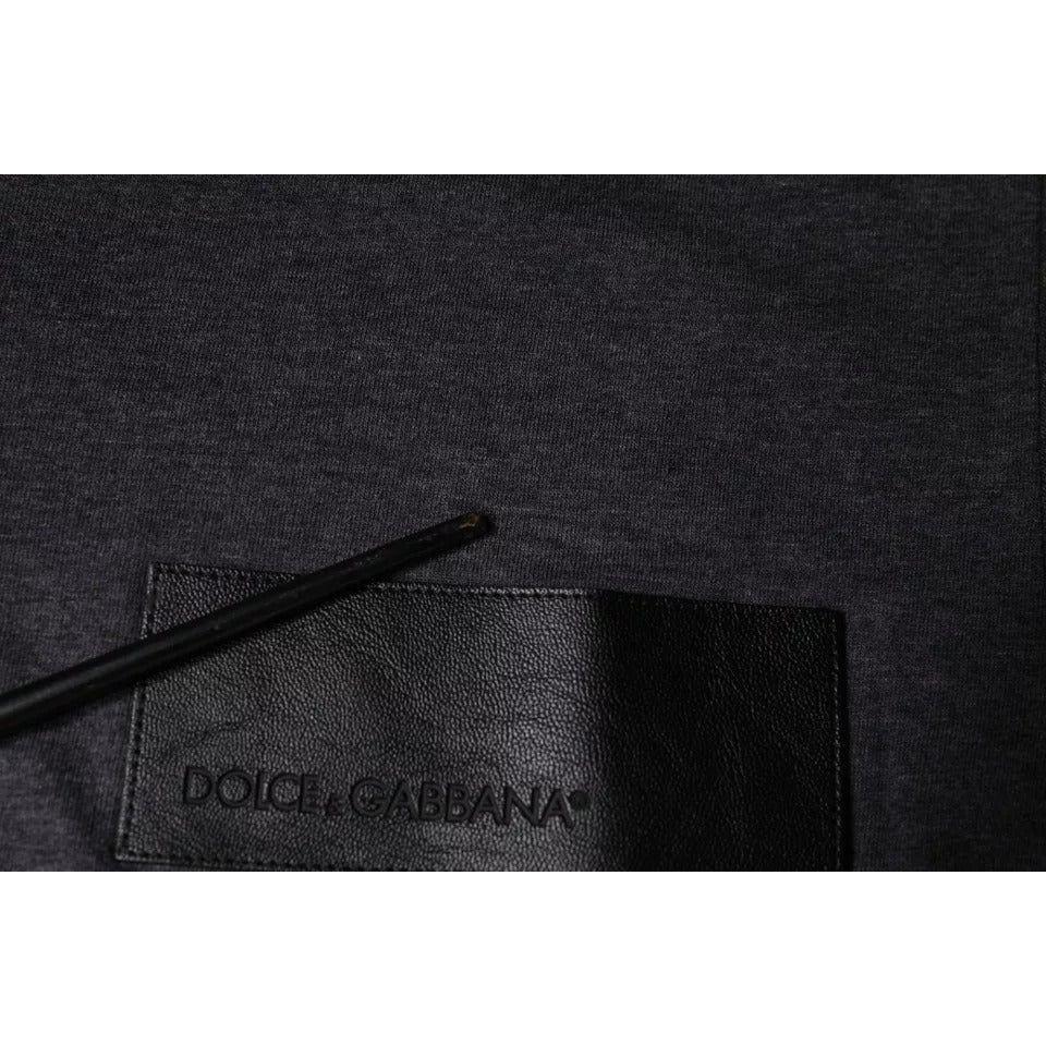 Dolce & Gabbana gray cotton t-shirt with logo patch, close-up view, repaired rip detail visible, Italian made, crew neck style.