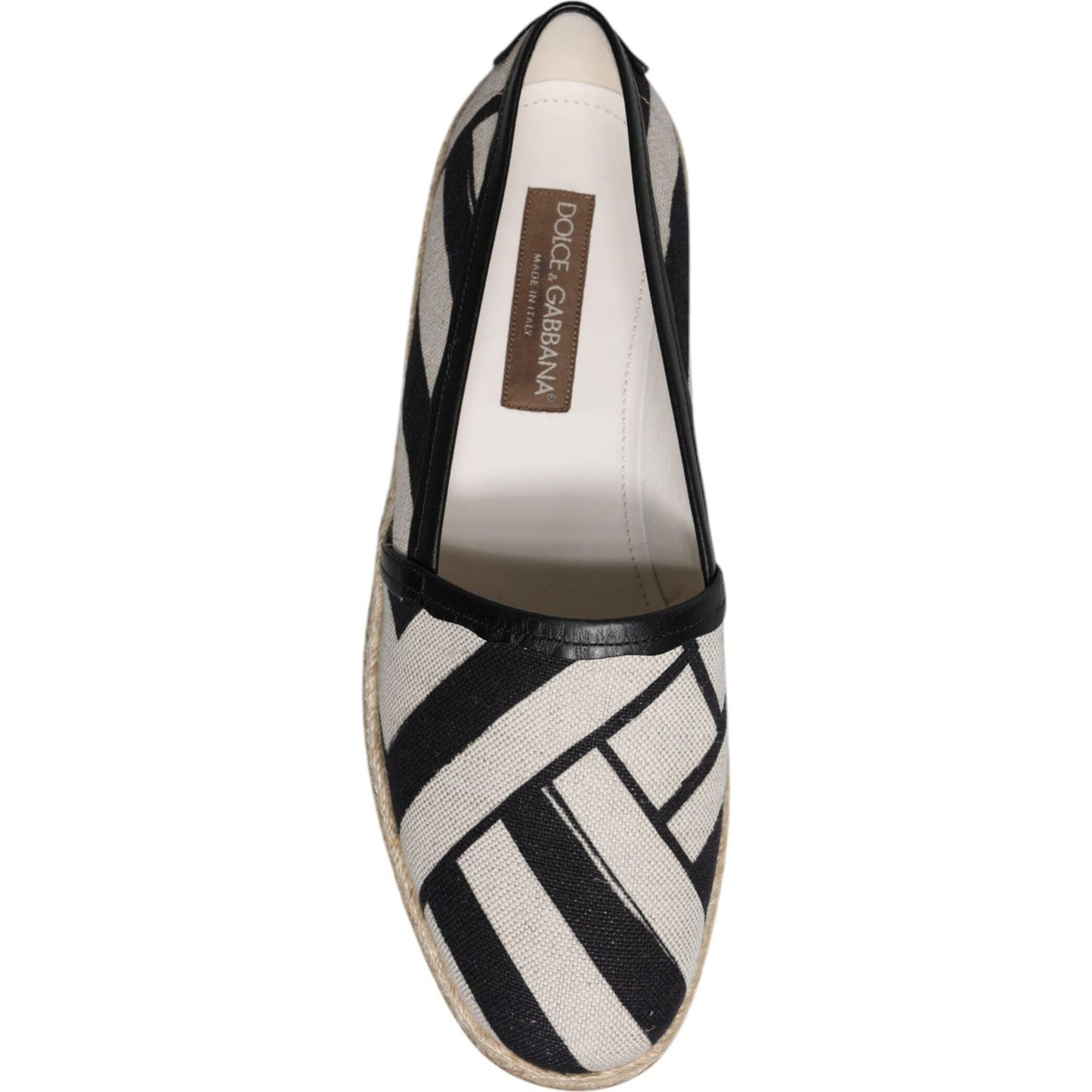 Dolce & Gabbana black white striped slip-on espadrille shoe, top view, featuring leather trim and logo details, luxury footwear.