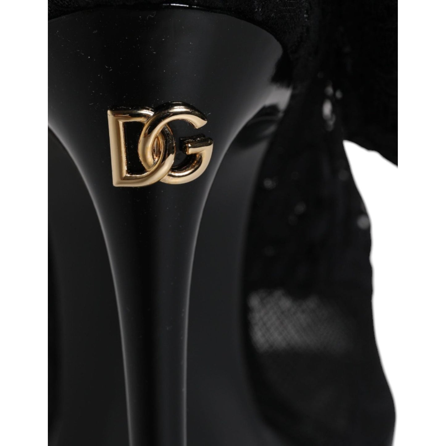 Close-up of Dolce & Gabbana black lace boot heel with gold DG logo detail, showcasing luxury Italian craftsmanship.
