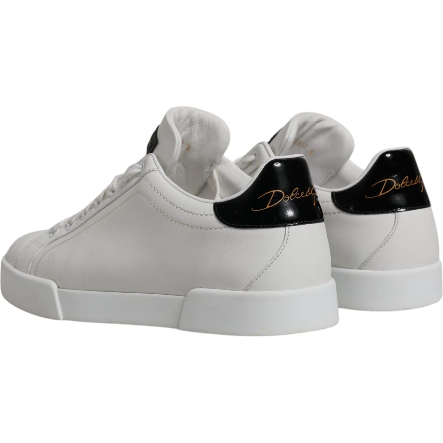 Dolce & Gabbana white leather low top sneakers with black heel logo, rubber sole, and lace-up closure, slightly preowned condition.