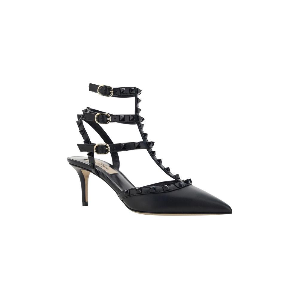 Valentino Garavani black leather Rockstud pumps with geometric toe and stiletto heel, featuring iconic stud details and adjustable ankle straps.