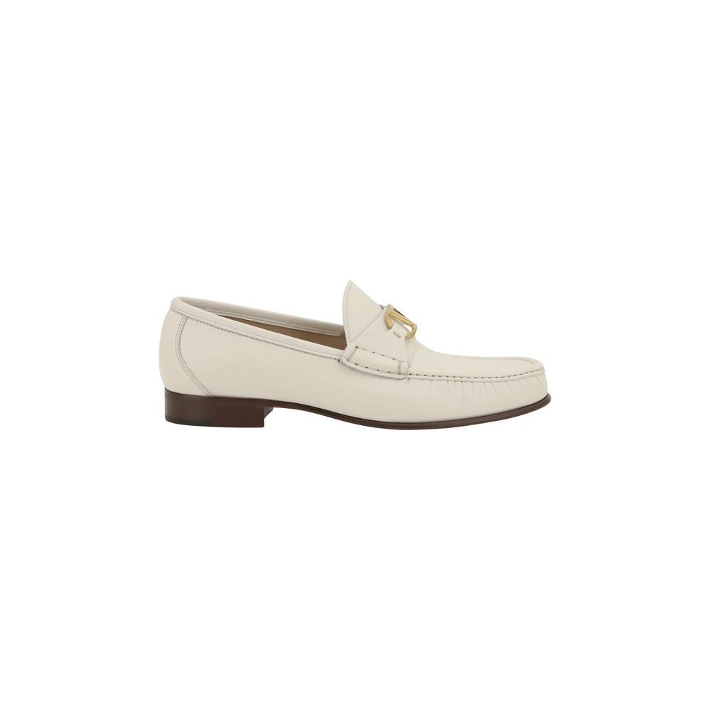Valentino Garavani leather loafers with VLogo plaque and block heel, elegant contrast logo insole, modern refined design.