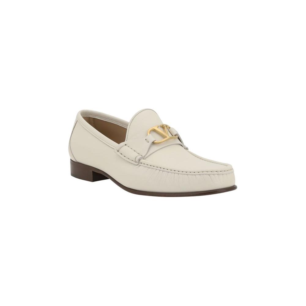 Valentino Garavani leather loafers with block heel and gold VLogo plaque on front, featuring a contrasting logo insole.