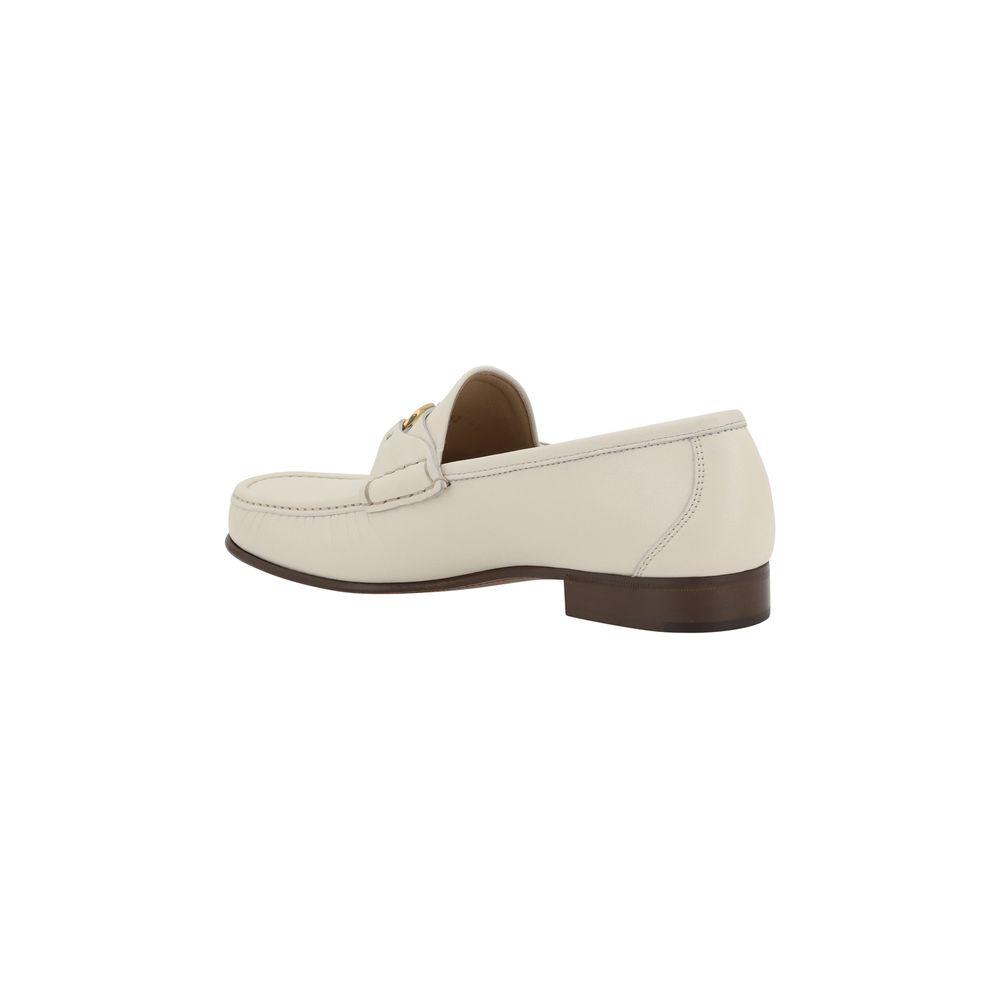 Valentino Garavani leather loafers with block heel and VLogo plaque, side view.