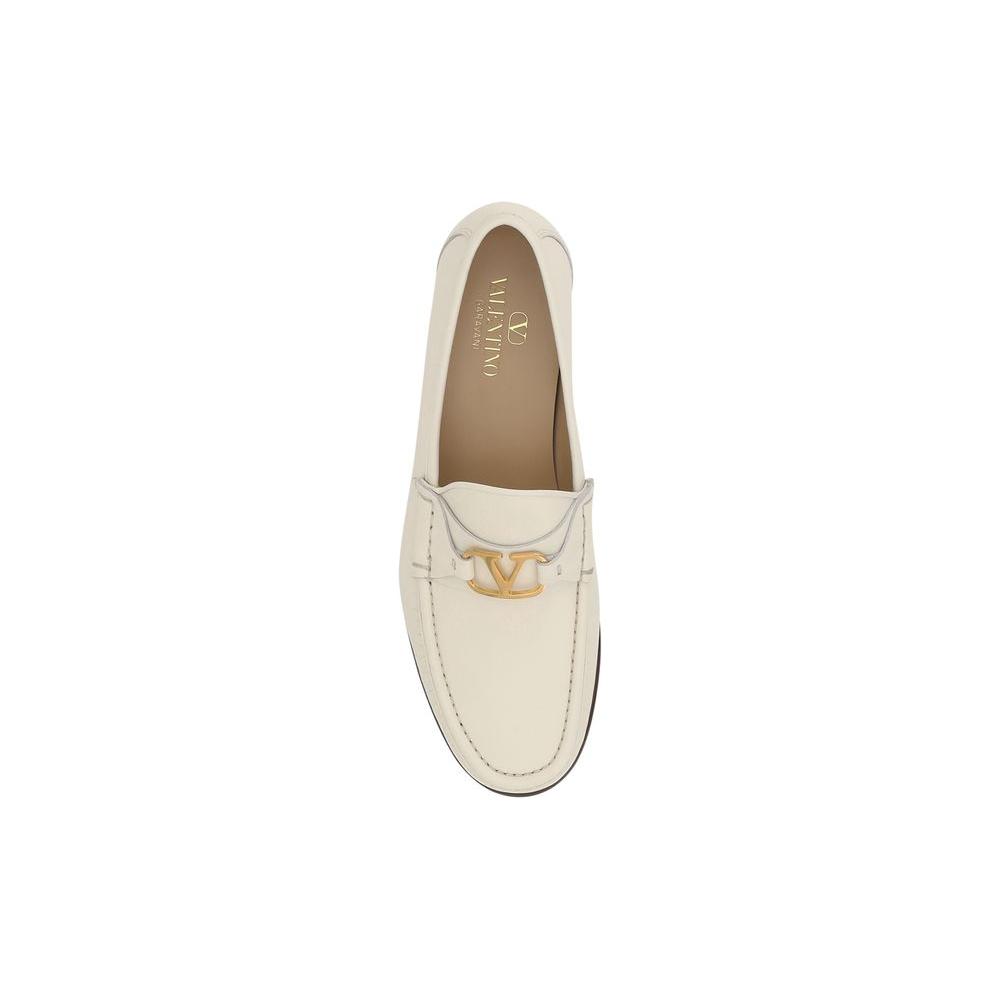Valentino Garavani leather loafers with block heel and VLogo plaque, featuring a contrasting logo insole for a refined look.