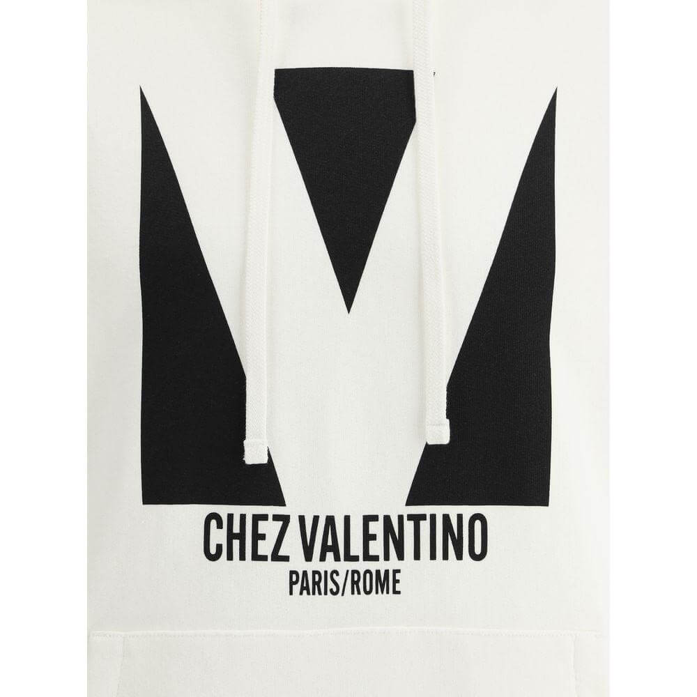 Valentino cotton hoodie with adjustable drawstring, ribbed details, and iconic maxi monogram print. Regular fit. Front kangaroo pocket.