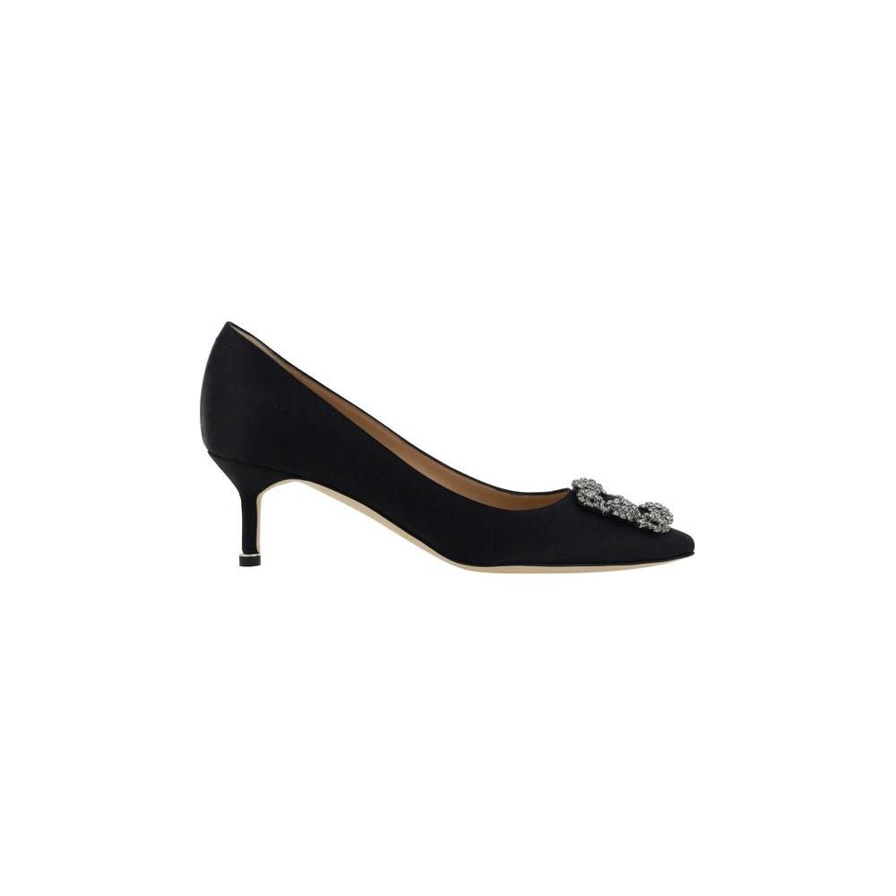 Black Manolo Blahnik Hangisi Pumps with Swarovski crystal buckle and almond toe, featuring leather stiletto heel and logo-embossed insole.