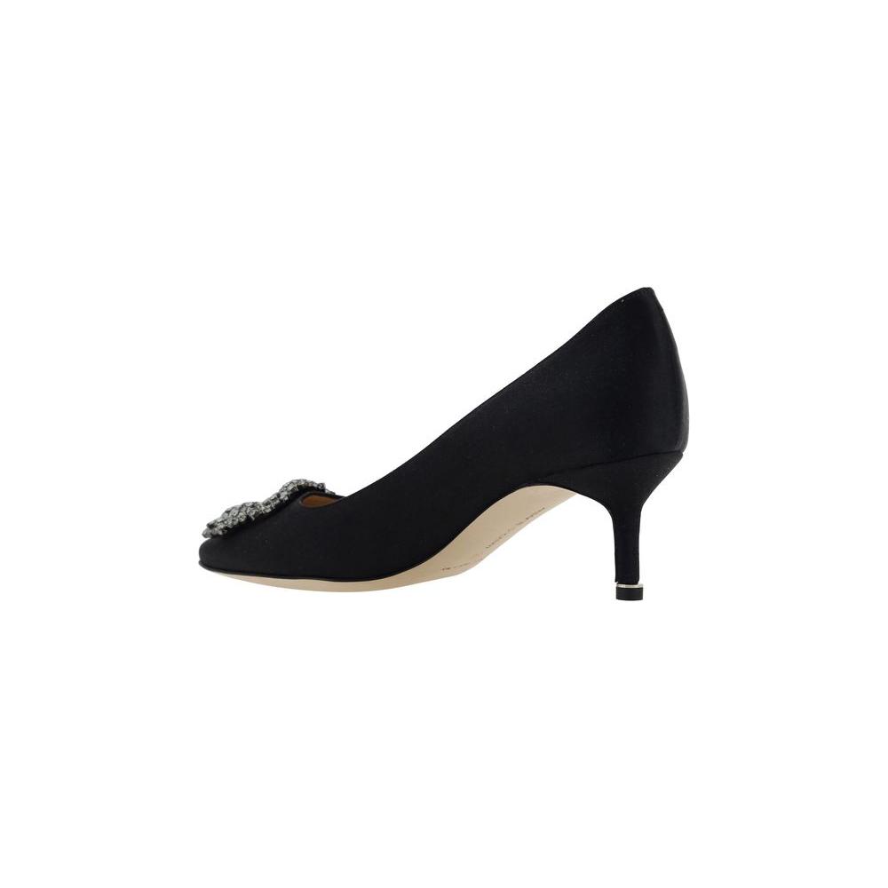 Black Manolo Blahnik Hangisi pump with Swarovski crystal buckle, silk satin finish, almond toe, and leather stiletto heel.