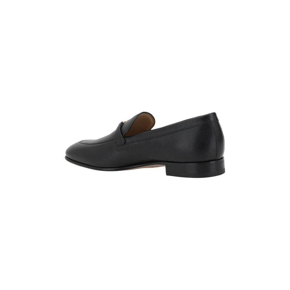 Valentino Garavani black leather loafers with VLogo plaque, featuring a round toe and slip-on design for comfort and style.