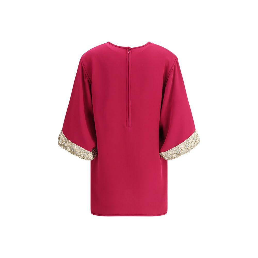 Back view of Valentino's Jewel Top featuring flared sleeves with pearl and bead embroidery, elegant crew neck, and zipper closure.