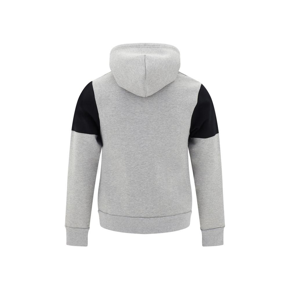 Back view of Balenciaga cotton hoodie with contrasting black panel design and hood, showcasing modern urban style.