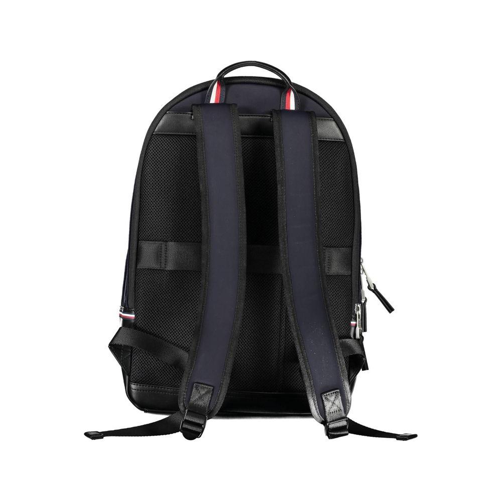 Back view of Tommy Hilfiger blue men’s backpack with adjustable straps and handle, showcasing durable polyethylene material and zip closure.