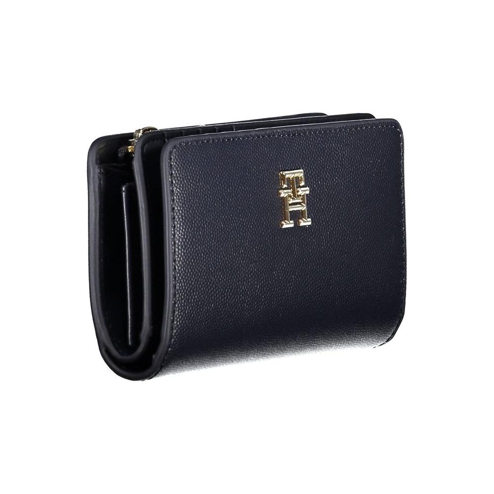 Tommy Hilfiger blue wallet for women, featuring polyethylene material, zip closure, and iconic logo, ideal for organization and style.