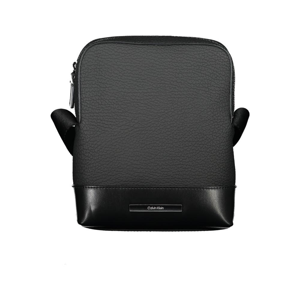 Calvin Klein sleek black shoulder bag with contrasting details and adjustable strap, featuring external and internal pockets for practical use.