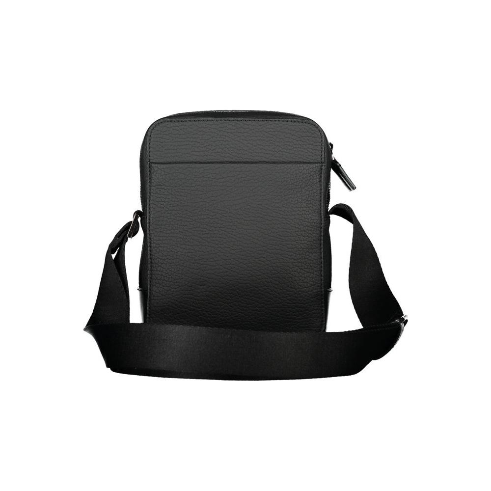 Calvin Klein sleek black shoulder bag with adjustable strap and contrasting details for men, featuring a zip closure and external pocket.