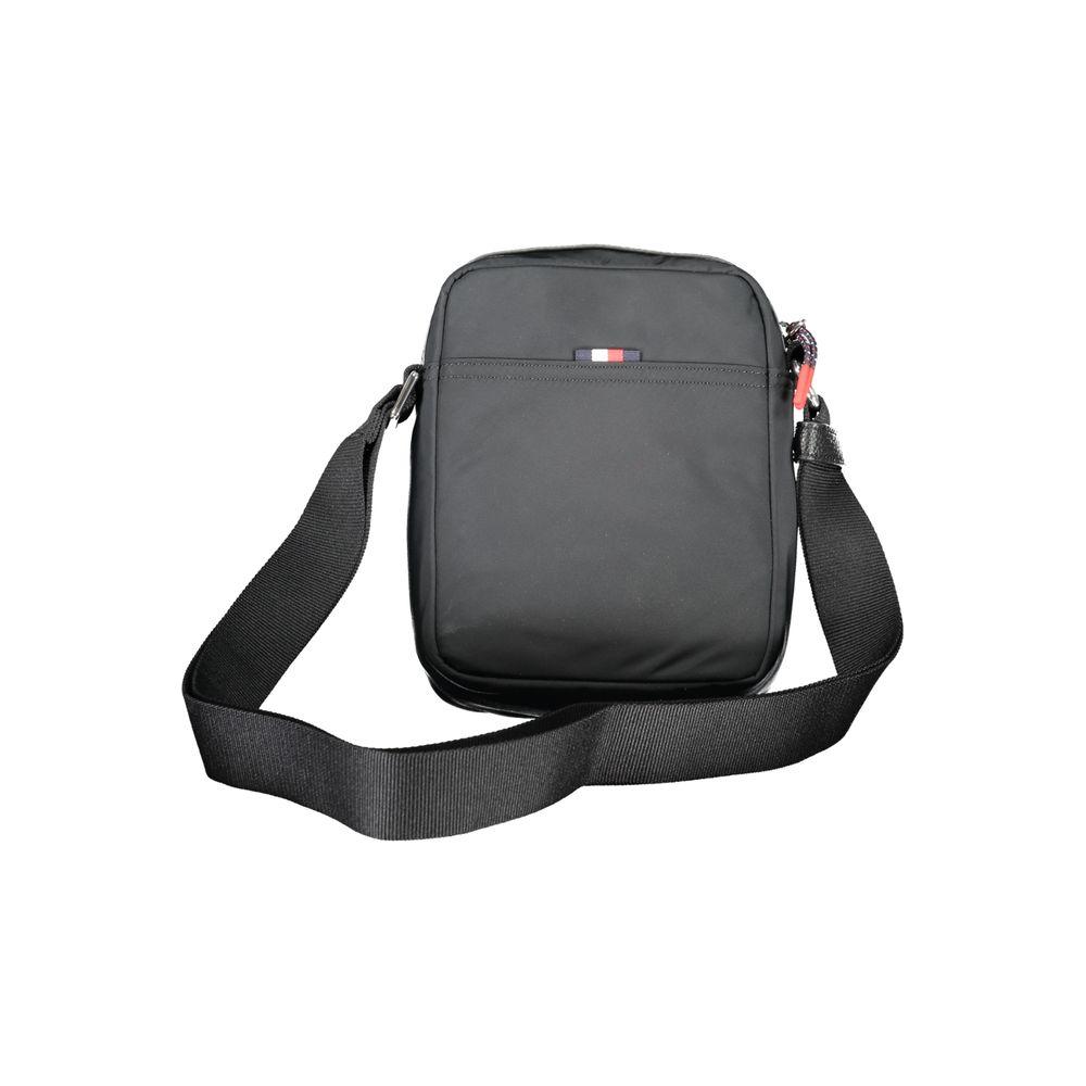 Tommy Hilfiger black shoulder bag with adjustable strap and logo, featuring external and internal pockets made from 50% recycled polyester.