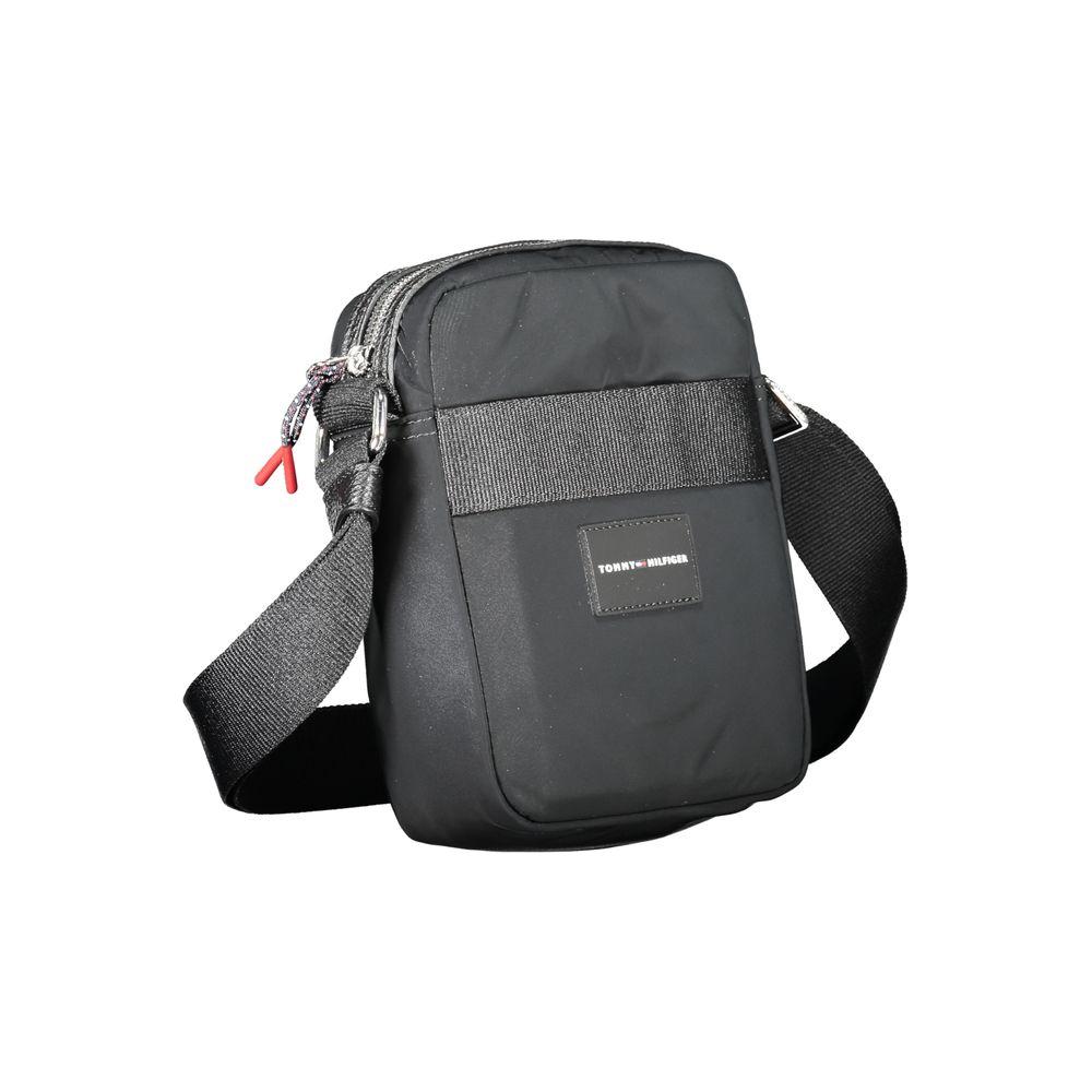 Tommy Hilfiger black shoulder bag with adjustable strap, external and internal pockets, zip closure, and logo. Made from 50% recycled polyester.