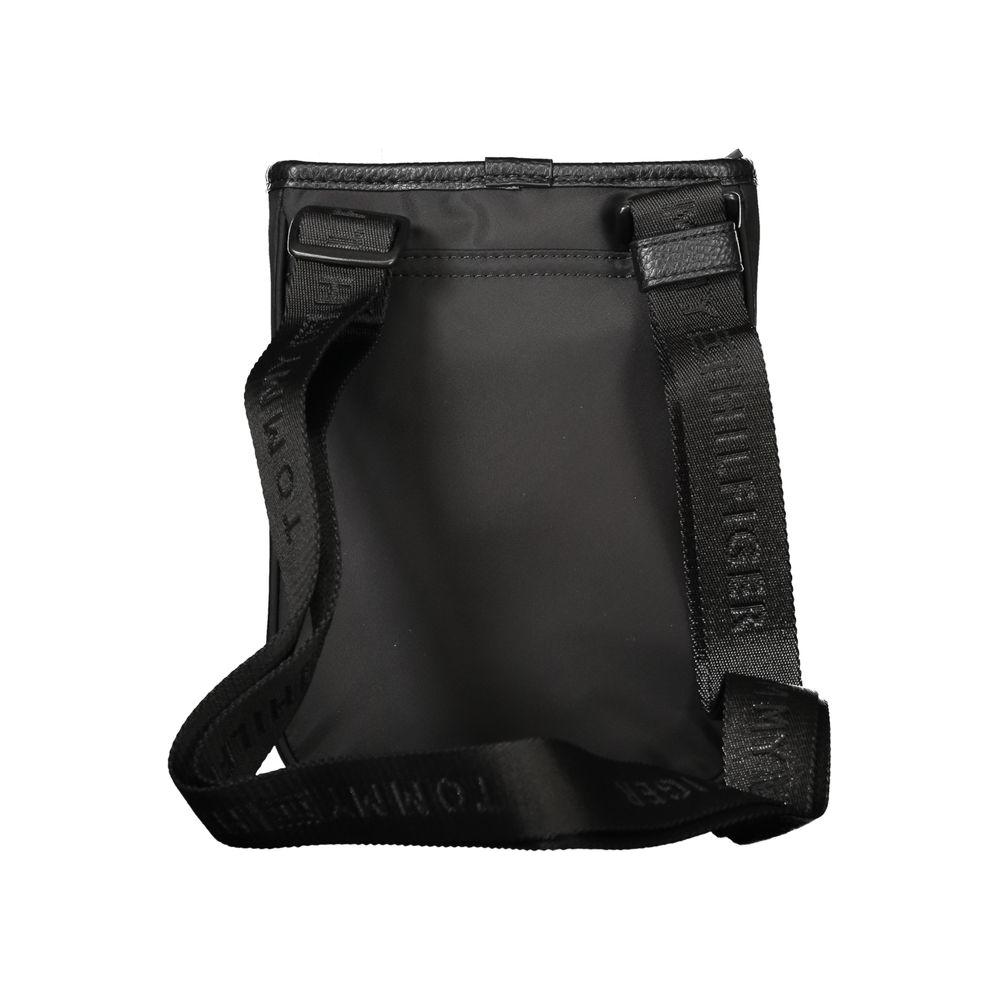 Tommy Hilfiger black polyester men's shoulder bag with adjustable strap and logo detailing, rear view.