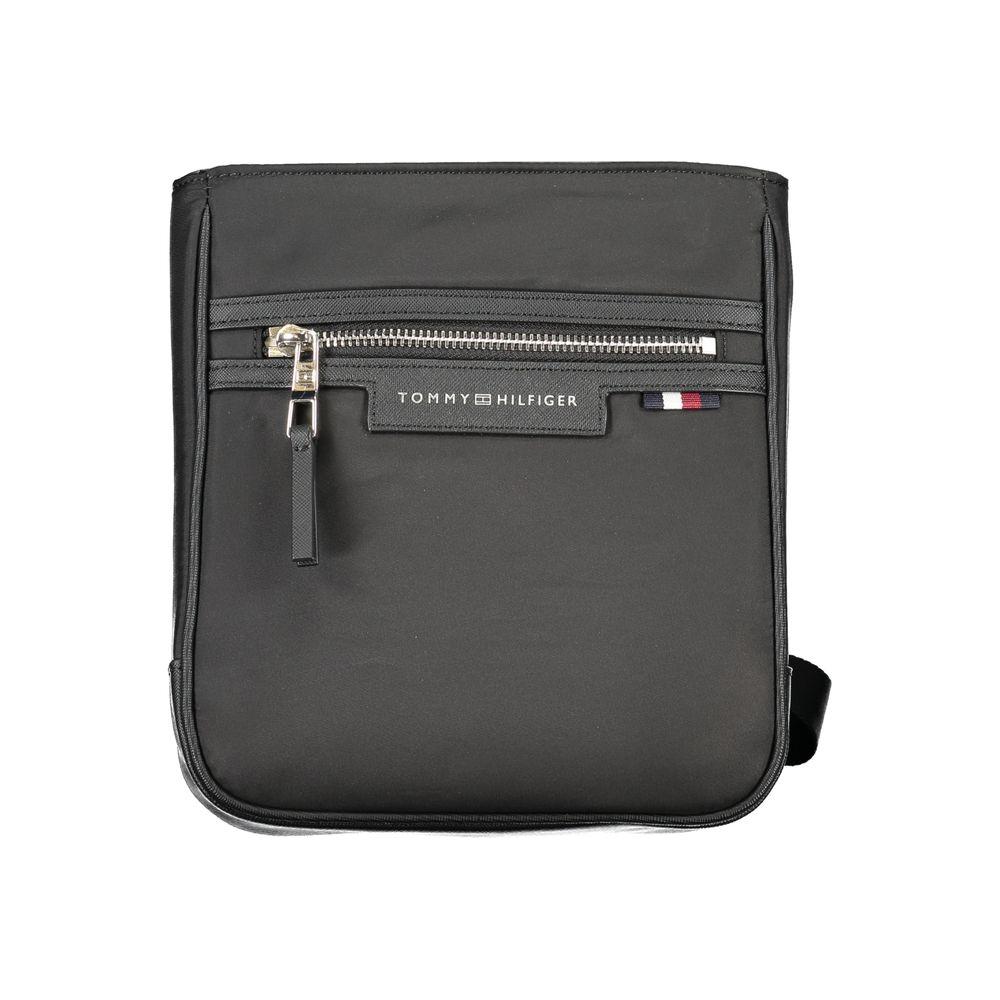 Tommy Hilfiger black shoulder bag with adjustable strap, zip closure, logo detail, and pockets, made from 50% recycled polyester.