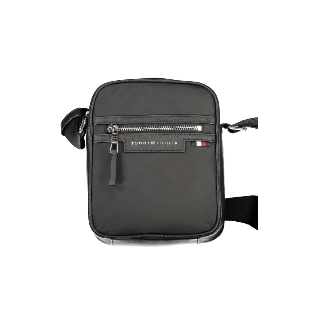 Tommy Hilfiger black polyester shoulder bag with adjustable strap, external and internal pockets, zip closure, and logo.