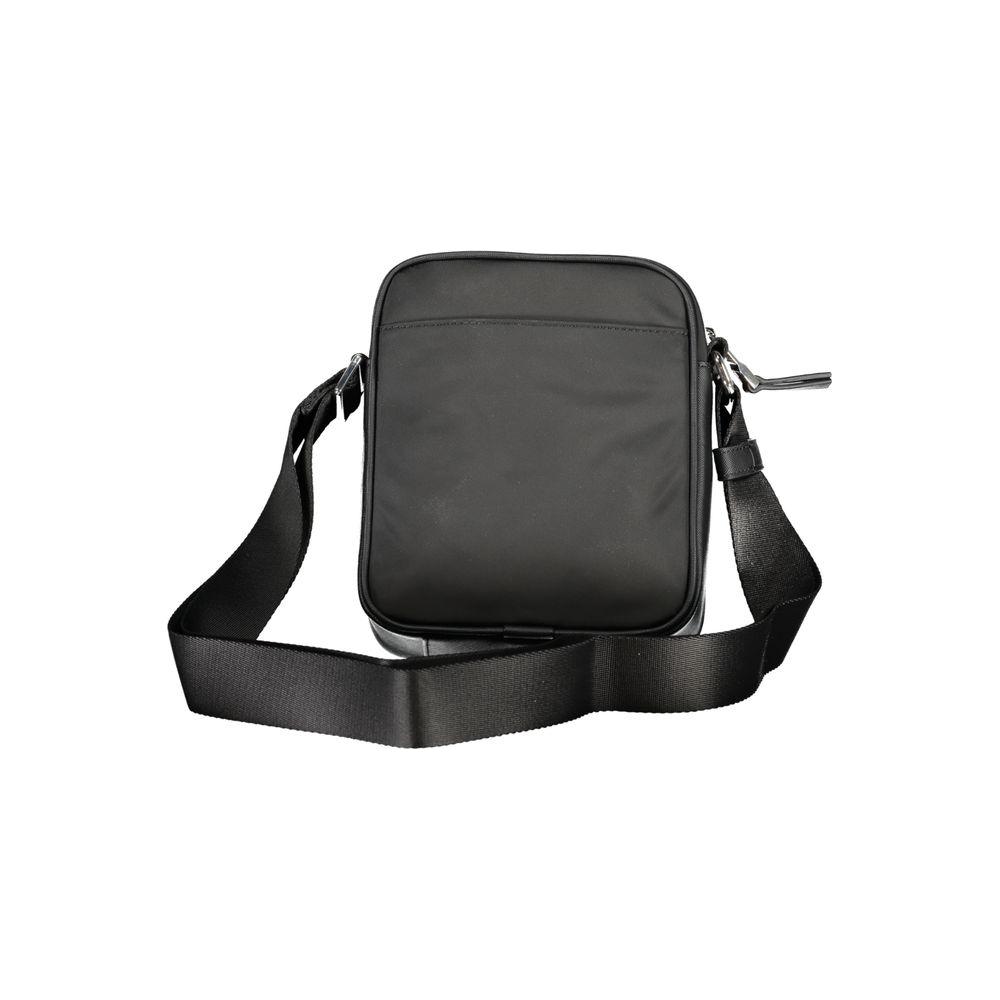Tommy Hilfiger black polyester shoulder bag with adjustable strap, zip closure, external and internal pockets, eco-friendly material.