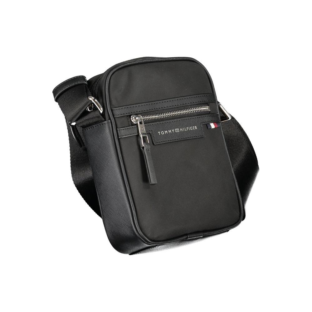 Tommy Hilfiger black polyester shoulder bag with adjustable strap, external pocket, zip closure, and logo. Eco-friendly material.