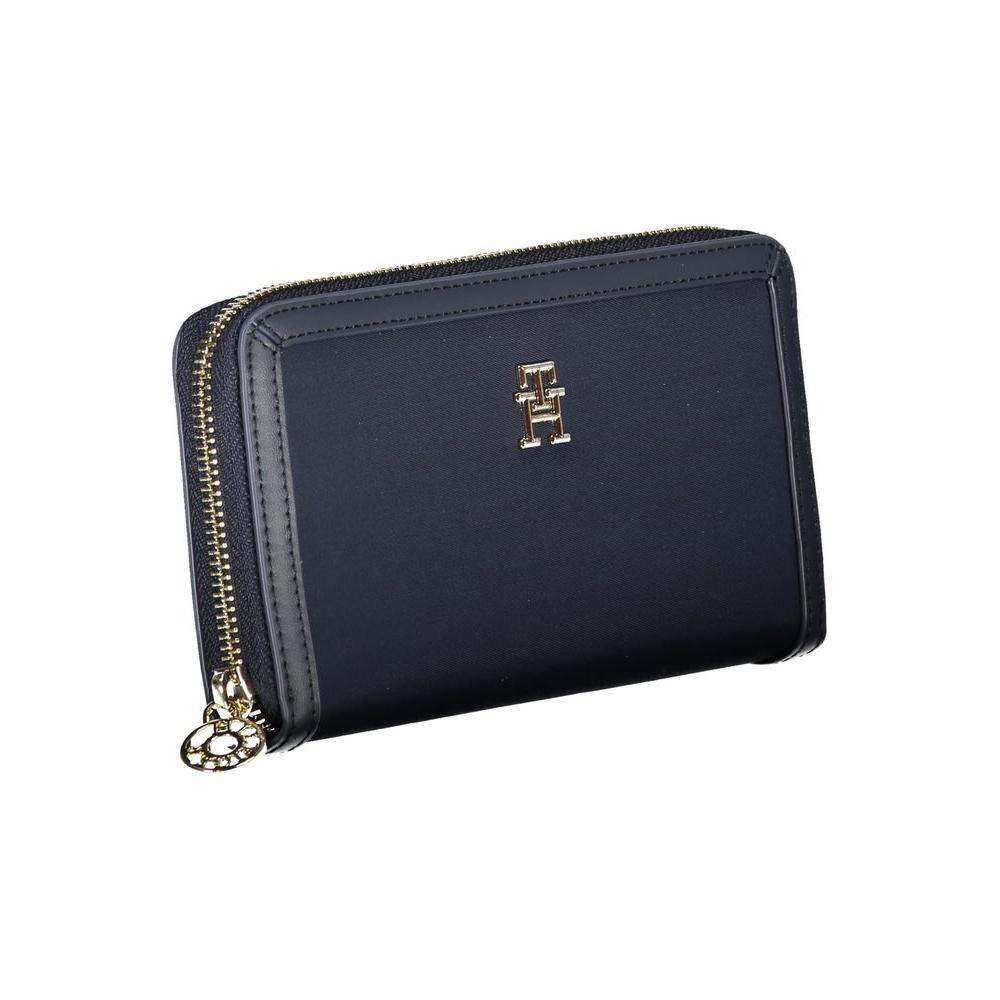 Tommy Hilfiger sustainable blue wallet with zip, featuring iconic logo and eco-friendly design from recycled polyester.