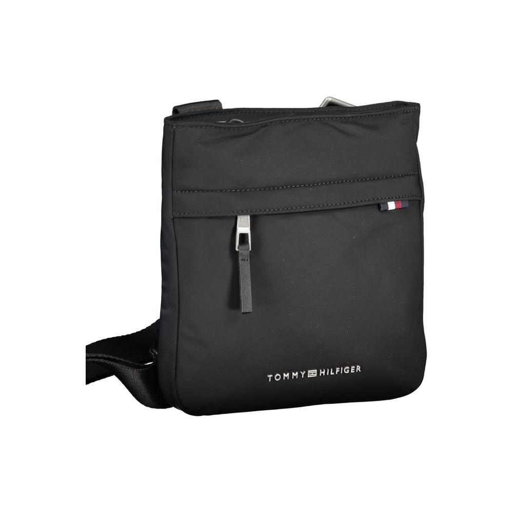 Tommy Hilfiger black shoulder bag with adjustable strap, logo, and multiple pockets, made from recycled polyester.