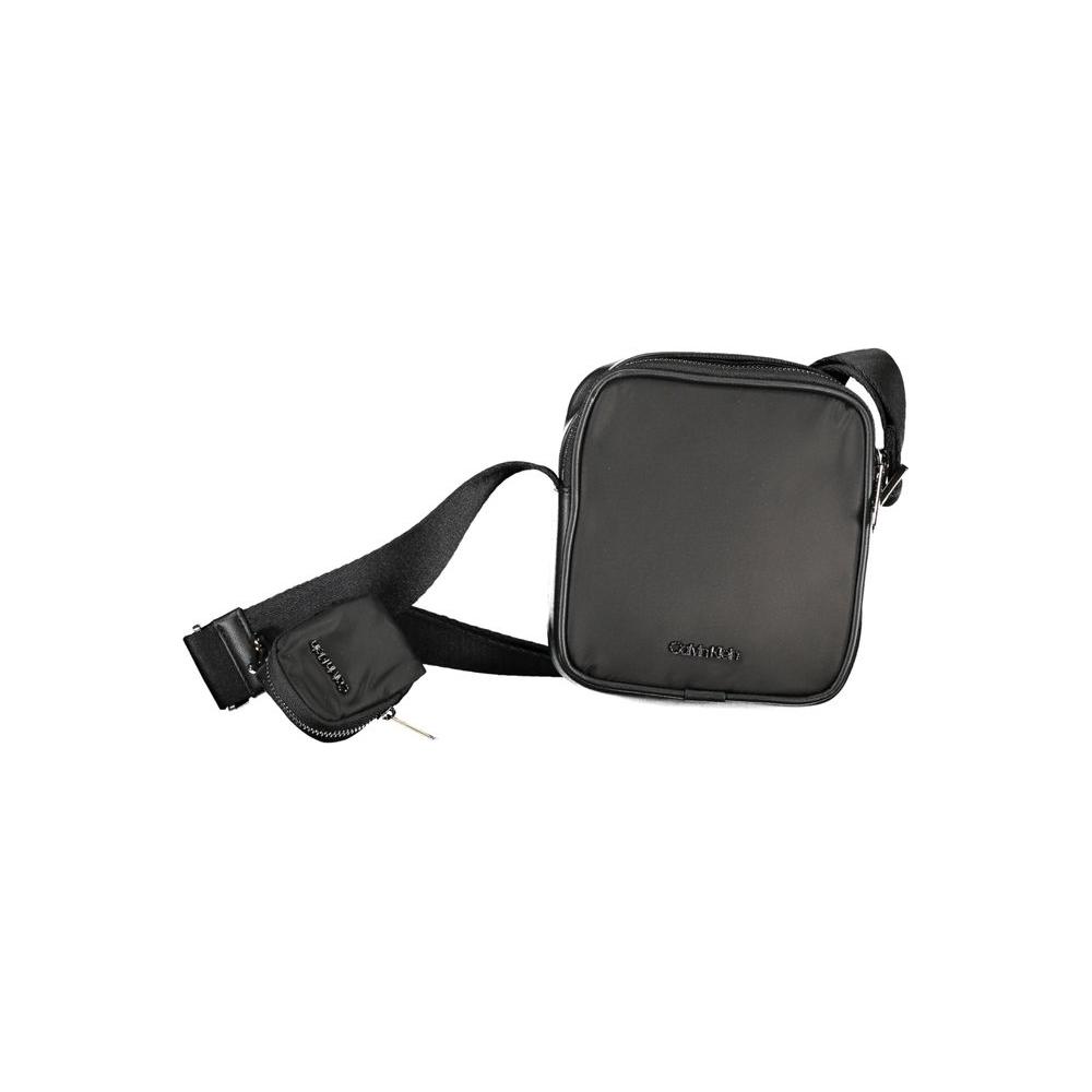 Calvin Klein black polyester shoulder bag with adjustable strap, zip closure, internal pocket, and removable coin purse.
