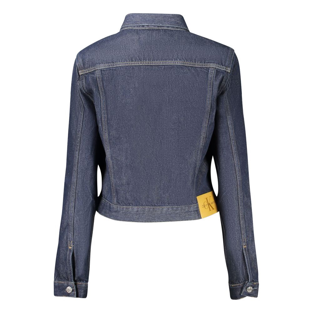 Back view of Calvin Klein blue denim women’s jacket with iconic logo patch.